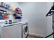 Well-organized laundry room with modern washer and dryer, and shelving for storage of essentials at 8443 Via Bella Notte, Orlando, FL 32836