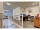 Upstairs landing area used as an office with neutral walls, wood floors, and white railings at 8443 Via Bella Notte, Orlando, FL 32836