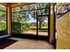 Enclosed patio area with tiled floor and a view of the backyard and landscaping at 8443 Via Bella Notte, Orlando, FL 32836