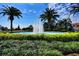 Beautiful water fountain surrounded by palm trees, lush greenery, and lovely landscaping under a sunny sky at 8443 Via Bella Notte, Orlando, FL 32836