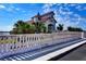 A home exterior view with a water view, featuring a white railing and lush greenery at 8443 Via Bella Notte, Orlando, FL 32836