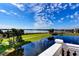 Scenic water view with blue skies, lush greenery, walking path, and palm trees from a balcony at 8443 Via Bella Notte, Orlando, FL 32836