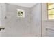 Modern bathroom features a walk-in shower with stylish marble-look tiles at 8851 Hillsdale Dr, Orlando, FL 32818