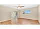 This bedroom features hardwood floors, a ceiling fan, and lots of natural light at 8851 Hillsdale Dr, Orlando, FL 32818