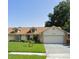 Charming single-Gathering home with a lush green lawn and a two-car garage at 8851 Hillsdale Dr, Orlando, FL 32818