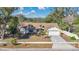 Aerial view of the home, showcasing the lawn and the driveway at 8851 Hillsdale Dr, Orlando, FL 32818