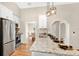 Well-lit kitchen featuring stainless steel appliances and an open view to the dining room at 8851 Hillsdale Dr, Orlando, FL 32818