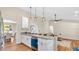 Spacious kitchen featuring white cabinetry, granite counters, and a view into the living room at 8851 Hillsdale Dr, Orlando, FL 32818