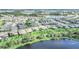 Community aerial view with multiple homes and a serene lake backdrop at 9014 Sonoma Coast Dr, Winter Garden, FL 34787