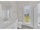 Bright bathroom with a walk-in shower and a door that leads to the yard at 9014 Sonoma Coast Dr, Winter Garden, FL 34787