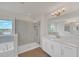 Bright bathroom with a soaking tub and glass shower with neutral tiling at 9014 Sonoma Coast Dr, Winter Garden, FL 34787