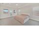 Spacious bedroom with a tray ceiling, plush carpeting, and access to a private balcony at 9014 Sonoma Coast Dr, Winter Garden, FL 34787