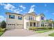 Charming two-story home featuring blue shutters, a three-car garage, and manicured landscaping at 9014 Sonoma Coast Dr, Winter Garden, FL 34787