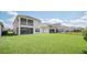 Home exterior featuring a large yard, screened lanai, and two-story design at 9014 Sonoma Coast Dr, Winter Garden, FL 34787