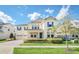 Charming two-story home featuring blue shutters, a three-car garage, and manicured landscaping at 9014 Sonoma Coast Dr, Winter Garden, FL 34787