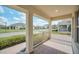 Inviting covered front porch with brick flooring, white railings and serene neighborhood views at 9014 Sonoma Coast Dr, Winter Garden, FL 34787