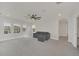 Living area with grey couch, carpet, and a ceiling fan at 9014 Sonoma Coast Dr, Winter Garden, FL 34787