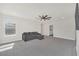 Large living room with a ceiling fan, carpet, and a grey sofa at 9014 Sonoma Coast Dr, Winter Garden, FL 34787