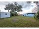 Spacious backyard featuring a shed, a house and mature trees for added privacy at 913 Lake Ave, Edgewater, FL 32132