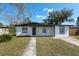 Charming single-story home with a well-manicured front yard and a gray concrete walkway leading to the front door at 913 Lake Ave, Edgewater, FL 32132