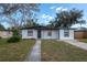 Charming single-story home with a well-manicured front yard and a gray concrete walkway leading to the front door at 913 Lake Ave, Edgewater, FL 32132