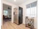 Kitchen space featuring stainless steel refrigerator, wood floors, and open access to the living room at 913 Lake Ave, Edgewater, FL 32132