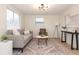 Inviting living room with a comfortable gray sofa, stylish rug, modern lighting, and ample natural light at 913 Lake Ave, Edgewater, FL 32132