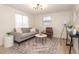 Inviting living room with a comfortable gray sofa, stylish rug, modern lighting, and ample natural light at 913 Lake Ave, Edgewater, FL 32132