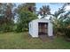 An open storage shed in the backyard with mature landscaping at 913 Lake Ave, Edgewater, FL 32132