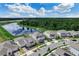 Aerial view of the neighborhood with a large pond and green trees at 9752 Petition Way, Orlando, FL 32832