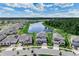 Wide aerial shot showcasing a new neighborhood surrounding a scenic lake at 9752 Petition Way, Orlando, FL 32832