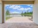 Paver patio offers an outdoor space with scenic lake view framed by the home's architecture at 9752 Petition Way, Orlando, FL 32832