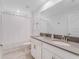 This bathroom features double sinks, white cabinetry, and a shower and tub combo at 9752 Petition Way, Orlando, FL 32832