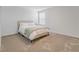 A well-lit bedroom with plush carpet and a large window provides comfort at 9752 Petition Way, Orlando, FL 32832