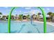 Fun splash pad area with colorful fountains, palm trees, and a view of the community pool at 9752 Petition Way, Orlando, FL 32832