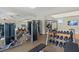 Bright fitness center with weight machines, free weights, and mounted televisions for entertainment at 9752 Petition Way, Orlando, FL 32832