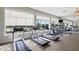 Well-equipped fitness center with treadmills, ellipticals, and large windows overlooking the community at 9752 Petition Way, Orlando, FL 32832