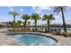 Relaxing hot tub area surrounded by lush landscaping and swaying palm trees near the community pool at 9752 Petition Way, Orlando, FL 32832