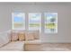 The well lit living room with three windows with views of the pond. The room is warmly decorated at 9752 Petition Way, Orlando, FL 32832