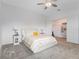 Bright main bedroom featuring soft carpet, ceiling fan, and an adjacent walk-in closet at 9752 Petition Way, Orlando, FL 32832