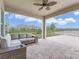 Covered patio with outdoor seating overlooking a serene pond and beautiful neighborhood views at 9752 Petition Way, Orlando, FL 32832