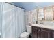 Charming bathroom boasting decorative wallpaper, a framed mirror, and a shower-tub combo at 1134 Glenwood Rd, Deland, FL 32720