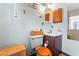 Cozy bathroom featuring a vanity with storage, a toilet with a wooden seat, and nautical-themed decor at 1134 Glenwood Rd, Deland, FL 32720
