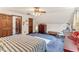 Spacious bedroom featuring vaulted ceilings, a ceiling fan, and cozy blue carpeting at 1134 Glenwood Rd, Deland, FL 32720