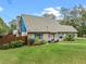 A well-maintained single Gathering brick home featuring blue trim, landscaping and ample yard space at 1134 Glenwood Rd, Deland, FL 32720