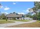 Charming single-story brick home with lush lawn, long driveway, detached garage, and blue trim at 1134 Glenwood Rd, Deland, FL 32720