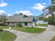 Charming single-story brick home with lush lawn, long driveway, detached garage, and blue trim at 1134 Glenwood Rd, Deland, FL 32720