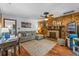 Bright living room featuring a stone fireplace, wood paneling, and modern furnishings at 1134 Glenwood Rd, Deland, FL 32720