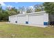 Large metal building featuring three bays, and a concrete apron in front, set on a grassy lot at 1134 Glenwood Rd, Deland, FL 32720