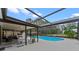 Inviting screened pool area featuring ample seating and a charming garden view at 1134 Glenwood Rd, Deland, FL 32720